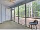 Screened porch with view of surrounding woods with a neutral color scheme at 103 Greencastle Dr, Goose Creek, SC 29445