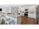 Bright kitchen with white cabinetry, stainless steel appliances, and hardwood flooring at 1030 Scotch Bonnet Way, Summerville, SC 29485
