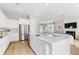 Bright modern kitchen with stainless steel appliances, island sink, and stylish lighting at 1041 Scotch Bonnet Way, Summerville, SC 29485