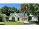 Charming single story home with manicured lawn, driveway, and a mature palm tree at 108 Alston Cir, Goose Creek, SC 29445