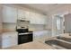 Well-lit kitchen featuring white cabinets, stainless steel appliances, and a stainless steel sink at 108 Alston Cir, Goose Creek, SC 29445