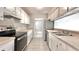 Bright kitchen showcasing modern appliances, white cabinets, and speckled countertops at 108 Alston Cir, Goose Creek, SC 29445