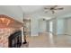 Bright living room features a brick fireplace, wood floors, vaulted ceiling, and modern ceiling fans at 108 Alston Cir, Goose Creek, SC 29445