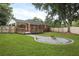 A beautiful backyard featuring a spacious lawn, wooden deck, and an inviting fire pit area at 1105 Crull Dr, Charleston, SC 29407