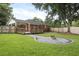 Spacious backyard featuring a wooden deck, a fire pit area, and a well-maintained lawn at 1105 Crull Dr, Charleston, SC 29407