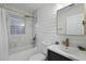 Stylish bathroom features tiled shower/tub, shiplap walls, and sleek fixtures, creating a modern, inviting space at 1105 Crull Dr, Charleston, SC 29407