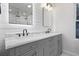 Modern bathroom features dual sinks, marble countertops, shiplap accent wall, and LED lighting for a luxurious feel at 1105 Crull Dr, Charleston, SC 29407