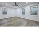Spacious bedroom with three large windows providing ample natural light and wood-look flooring throughout at 1105 Crull Dr, Charleston, SC 29407