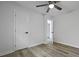 Bright bedroom features wood-look flooring and a ceiling fan, complemented by white walls and natural light at 1105 Crull Dr, Charleston, SC 29407
