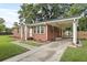 Well-maintained brick home with a carport, manicured lawn, and a paved driveway at 1105 Crull Dr, Charleston, SC 29407