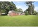Well-maintained brick home on a lush lawn, surrounded by mature trees, creating great curb appeal at 1105 Crull Dr, Charleston, SC 29407