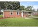 Quaint brick home with a carport, manicured lawn, and freshly mulched landscaping at 1105 Crull Dr, Charleston, SC 29407