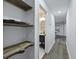 Hallway leading to bathroom with live-edge wooden shelves for storage and a modern color scheme at 1105 Crull Dr, Charleston, SC 29407