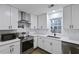 Bright kitchen with white cabinets, stainless steel appliances, and subway tile backsplash at 1105 Crull Dr, Charleston, SC 29407