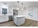 Bright kitchen with white cabinets, stainless steel appliances, island, and hardwood floors at 1105 Crull Dr, Charleston, SC 29407