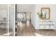 Inviting foyer showcasing wood floors, stylish console table and a mirror to brighten the space at 111 Battle Boat Blvd, Summerville, SC 29485