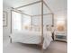 Serene bedroom with a wooden canopy bed, soft neutral tones, and elegant décor at 111 Battle Boat Blvd, Summerville, SC 29485