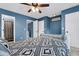 A spacious bedroom with an en suite bathroom, ceiling fan, and windows at 1120 Hidden Cove Dr # I, Mount Pleasant, SC 29464