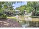 Peaceful community pond with a fountain, lush greenery, and townhouses in the backdrop at 1120 Hidden Cove Dr # I, Mount Pleasant, SC 29464