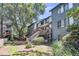 Rear exterior view of a townhouse with a wooden deck, stairs, and natural, shaded landscaping at 1120 Hidden Cove Dr # I, Mount Pleasant, SC 29464