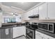 Efficient kitchen layout featuring stainless steel appliances, white cabinets, and an open serving hatch at 1120 Hidden Cove Dr # I, Mount Pleasant, SC 29464