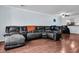 Spacious living room with hardwood floors and a large gray leather sectional couch with throw blankets at 1120 Hidden Cove Dr # I, Mount Pleasant, SC 29464