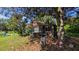 Backyard image showing a covered patio, some vegetation, and signs of deferred maintenance at 116 Stillfield Dr, Moncks Corner, SC 29461