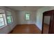Empty bedroom showing wood flooring, neutral walls, and two windows with mini blinds at 116 Stillfield Dr, Moncks Corner, SC 29461