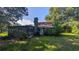 Exterior view shows home with a chimney and enclosed sunroom, set against lush greenery at 116 Stillfield Dr, Moncks Corner, SC 29461