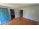 Empty living room with worn vinyl flooring, blue doors, and a dated chandelier at 116 Stillfield Dr, Moncks Corner, SC 29461