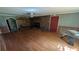 Living room with a brick fireplace, wood flooring, and a connecting room offering an open concept feel at 116 Stillfield Dr, Moncks Corner, SC 29461