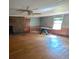 Bright living room featuring a brick fireplace, ceiling fan, and natural light from a large window at 116 Stillfield Dr, Moncks Corner, SC 29461