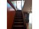Wooden staircase leading to the upper level, with an adjacent dining area visible below at 116 Stillfield Dr, Moncks Corner, SC 29461