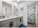 Nautical-themed bathroom featuring double sinks, marine decor, and a separate shower room at 118 Lagoona Dr, Summerville, SC 29483