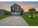 Beautiful two-story home featuring an extended driveway and a vibrant green lawn at 118 Lagoona Dr, Summerville, SC 29483