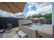 A private backyard area with a hot tub, umbrella, and surrounding green landscape at 118 Lagoona Dr, Summerville, SC 29483