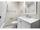 This bathroom features white cabinets and a white tiled shower/tub, creating a clean and modern aesthetic at 1203 Forestwood Dr, Charleston, SC 29407