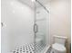 Elegant bathroom with glass-enclosed shower, black and white patterned tile, and toilet at 1203 Forestwood Dr, Charleston, SC 29407