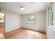 Well-lit bedroom with hardwood floors, two windows offering natural light, and neutral walls, creating a serene space at 1203 Forestwood Dr, Charleston, SC 29407