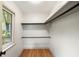 Walk-in closet with wood floors, shelving, and a view outside at 1203 Forestwood Dr, Charleston, SC 29407