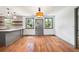 Bright dining area with hardwood floors, stylish gray trim, and natural light, seamlessly connected to the modern kitchen at 1203 Forestwood Dr, Charleston, SC 29407