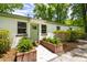 Charming front exterior with green front door, brick planters, and well-maintained landscaping at 1203 Forestwood Dr, Charleston, SC 29407
