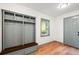 Mudroom featuring built-in storage with coat hooks, seating, and wood flooring and a window at 1203 Forestwood Dr, Charleston, SC 29407