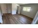 A bright bedroom features hardwood flooring, white walls, and windows overlooking a nice yard at 1229 Winston St, Charleston, SC 29407