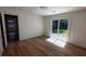 Bedroom with wood floors and sliding glass door leading to the backyard at 1229 Winston St, Charleston, SC 29407