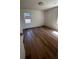 A spacious room offers wood floors, neutral walls and natural light from multiple windows at 1229 Winston St, Charleston, SC 29407