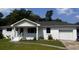 Charming single-story home with a well-manicured lawn and attached garage at 1229 Winston St, Charleston, SC 29407
