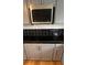 Kitchen detail featuring a stainless steel microwave and modern black subway tile at 1229 Winston St, Charleston, SC 29407