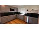 Stylish kitchen featuring gray cabinets, black countertops, and stainless steel appliances at 1229 Winston St, Charleston, SC 29407