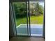 View through sliding glass doors to an outdoor patio and backyard with green grass at 1229 Winston St, Charleston, SC 29407